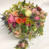 This bouquet and boutonniere is filled with sweet, fresh flowers with a