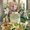 A seasonal spring garden of pastel blooms arranged in a floral wreath