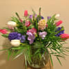 An abundance of spring flowers including tulips ,hyacinth ,and freesia arranged in