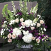 Beautiful white basket filled with lush flowers