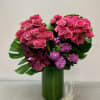 Gorgeous tall arrangement in a leaf covered vase.
