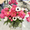 A stunning, lush arrangement that is overflowing with peonies, garden roses, anemones