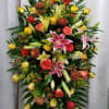 This bright, bold and timeless standing spray of pink  lilies, yellow