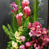 Tropical flower arrangement in the container Ginger and cymbidium orchids