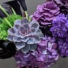 This tall sleek designer arrangement will include the best imported purple blooms
