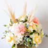 Gold ceramic square vase filled with roses, hydrangeas and boho accents, pampas