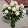 24 roses in a ti leaf wrapped tall glass cylinder. 