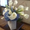 Imported blue hydrangea and white roses serve as the perfect backdrop for