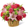 An natural woodchip basket holds a pretty bouquet of pink Asiatic lilies