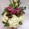 This arrangement comes complete with lavender roses, white calla lilies, pink hypericum
