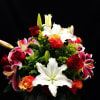 Send this amazing colorful,  assorted roses and mix lily arrangement 