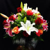 Send this amazing colorful,  assorted roses and mix lily arrangement 