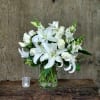 Beautifully designed in a modern cylinder with lilies,roses and snapdragons