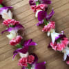 Mini carnations, orchids, and tuberose lei is a beautiful, lightweight fragrant lei.