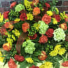 Beautiful spray perfectly designed for the top of a casket. Greens, yellows