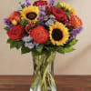 All-around arrangement with red roses and hypericum, autumn-colored roses, sunflowers, purple liatris