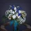 Oceanic design including blue and white fresh flowers and accents.
STANDARD: FIRST PHOTO
DELUXE: