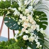24&quot; wreath covered in tropical green leaves. The flowers are roses and