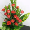 Beautiful arrangement of orange roses accompanied by greens that give a touch