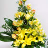 A beautiful and cheerful yellow floral arrangement that combines lilies, roses and