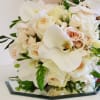 beautiful hand wrapped bouquet with garden roses and orchids.