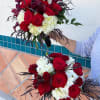 Hand tie bouquet using burgundy flowers. This is a mix of roses