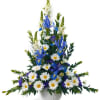 Pedestal arrangement including snapdragons, daisies, iris and statice. Simply beautiful for any