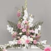 White Gladiolus cascade from a bouquet of Pink Snapdragons, Carnations and designer