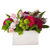 Bright pink blooms mingle among an assortment of lush greenery to create