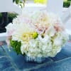 This darling arrangement includes, Roses, Dahlias if available Hydrangeas, Calla lilies if