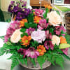 This basket design includes Roses, Alstroemeria, Mums, Carnations, and Stock set in