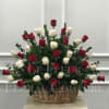 Crimson &amp; white roses designed in a wicker basket.