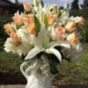 One dozen roses with white hydrangea and while lilies in white pitcher.
This