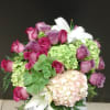 Made with purple roses, pink and green hydrangea 