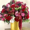 This stunning arrangement includes red roses and other gorgeous blooms. 