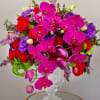 One of our signature modern arrangements in purple. Featuring Purple Orchids, Red
