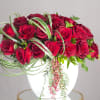 Two dozen Premium Red Roses wrapped in exotic greens, created to impress.