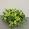An arrangement with orchids, succulents, coffee bean, and additional greenery.