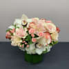 Amazing arrangement with roses, spray roses, orchids, hydrangeas, and coffee bean.