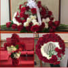 Roses and carnation casket spray, round wreath and standing cross.

*Pictured is an