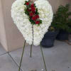 200 white carnations accented with white hydrangeas and red roses