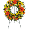 

A beautiful white cross made of daisies and carnation blooms is embellished