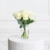 A hand-tied arrangement of 7 White Mondial Roses designed in a glass