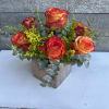 Beautifully assembled circus roses in a light bronze etched cube. Perfect table