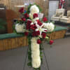 Fresh flower cross easel with lilies, roses, and daisies. 