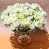Classic all white arrangement in a decorative vase. This arrangement is a