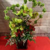 A elegant bouquet of red and green in a cube style vase.