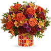 This radiant arrangement includes orange roses, light orange alstroemeria, purple button spray