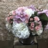 Stunning arrangement with light colors for every occasion. This arrangement has roses
