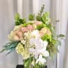 A beautiful and light mixed arrangement of pale pink roses, white hydrangeas